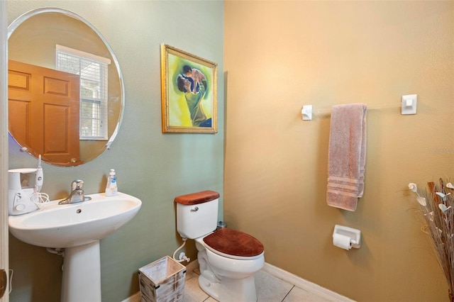 bathroom with tile patterned flooring and toilet