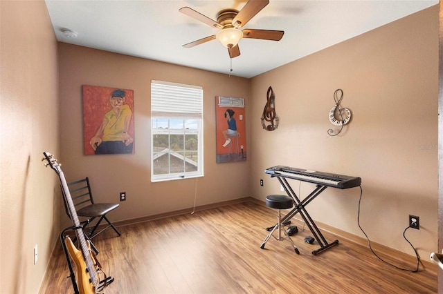 misc room featuring light wood-type flooring and ceiling fan