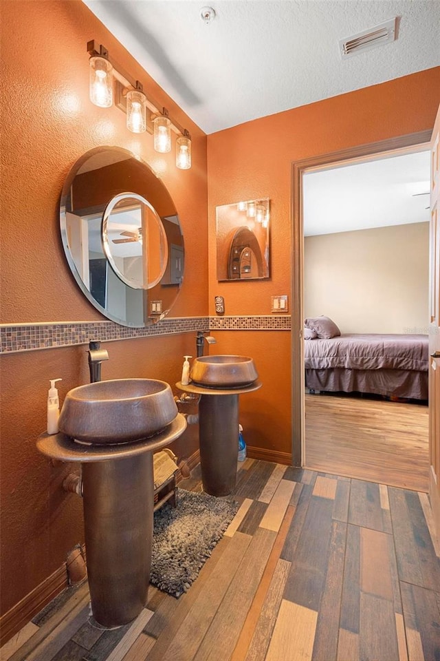 bathroom with wood-type flooring