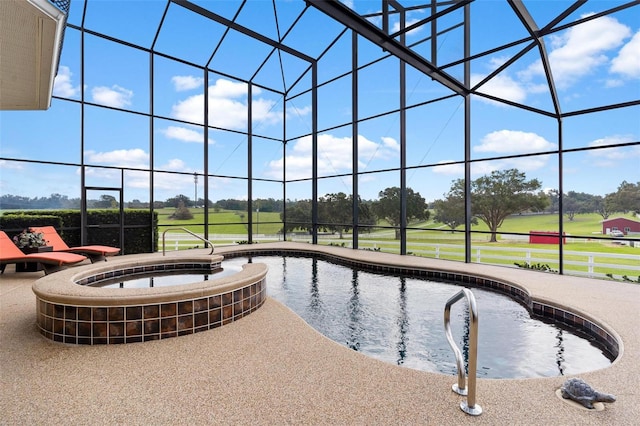 view of swimming pool featuring an in ground hot tub, a patio, glass enclosure, and a yard