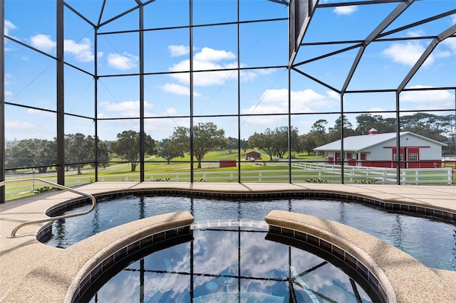 view of pool featuring glass enclosure