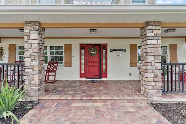 doorway to property featuring a porch