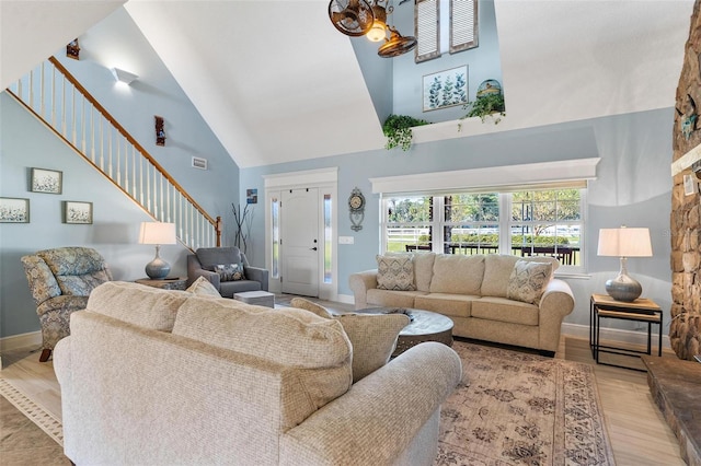 living room featuring light hardwood / wood-style flooring and high vaulted ceiling