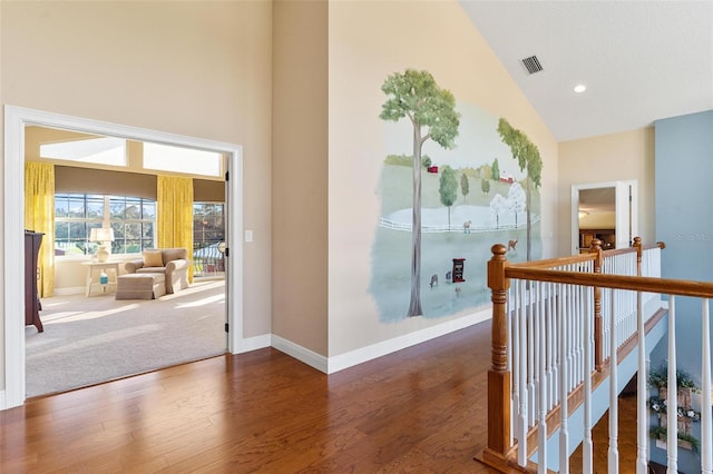 corridor featuring dark hardwood / wood-style floors and high vaulted ceiling