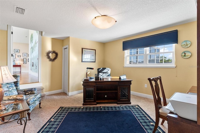 carpeted office featuring a textured ceiling