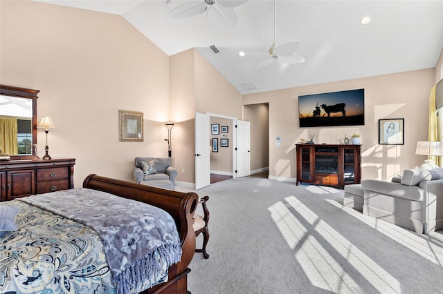 carpeted bedroom with ceiling fan and high vaulted ceiling