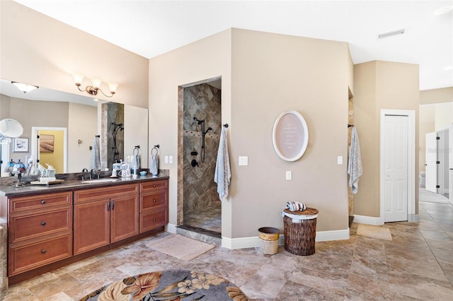 bathroom featuring vanity and tiled shower