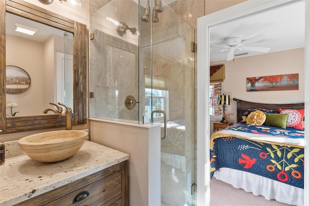 bathroom featuring vanity, a shower with shower door, and ceiling fan