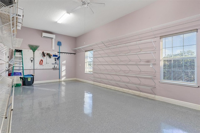 garage with ceiling fan and an AC wall unit