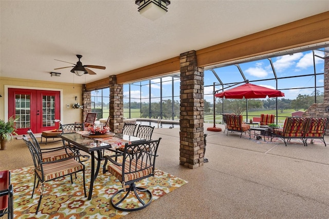 view of patio / terrace with french doors, glass enclosure, and ceiling fan