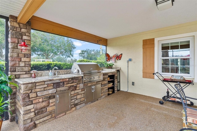 view of patio / terrace featuring area for grilling, an outdoor kitchen, and sink