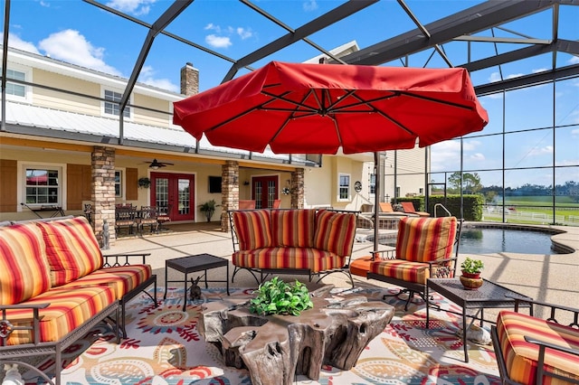 view of patio featuring an outdoor living space, a lanai, and ceiling fan