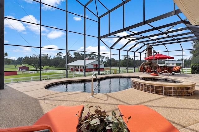 view of swimming pool featuring a patio, an in ground hot tub, and a lanai