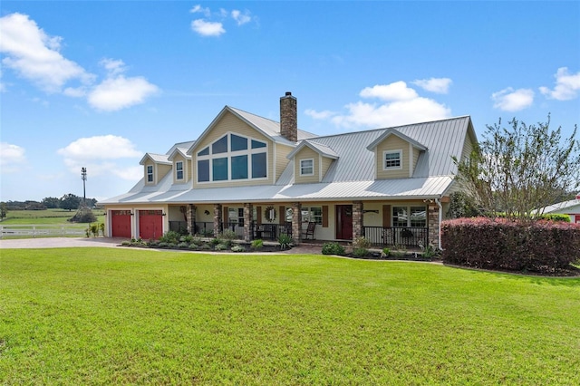 view of front of property featuring a front yard, a porch, and a garage