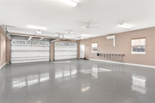 garage with a garage door opener, ceiling fan, and a wall mounted AC