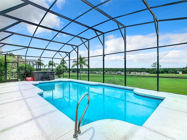 view of pool with glass enclosure, a yard, a hot tub, and a patio