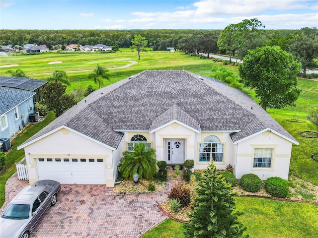 139 Belfry Dr, Davenport, FL 33897 - ranch-style home with stucco siding, roof with shingles, an attached garage, driveway, and central AC unit
