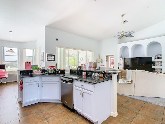 kitchen featuring ceiling fan, pendant lighting, sink, white cabinetry, and dark stone countertops