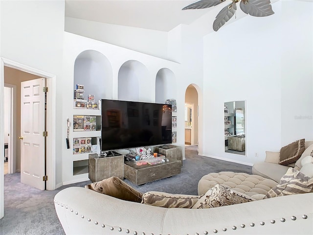 living room featuring ceiling fan, carpet floors, and high vaulted ceiling