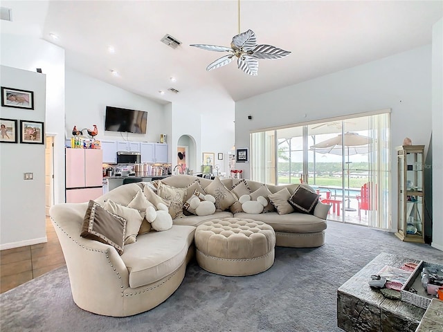 139 Belfry Dr, Davenport, FL 33897 - living area with high vaulted ceiling, a ceiling fan, arched walkways, and baseboards