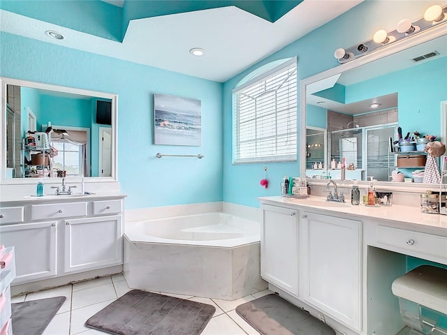 bathroom featuring plus walk in shower, tile patterned flooring, plenty of natural light, and vanity