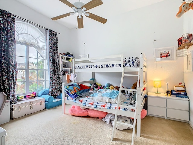 bedroom featuring light carpet and ceiling fan