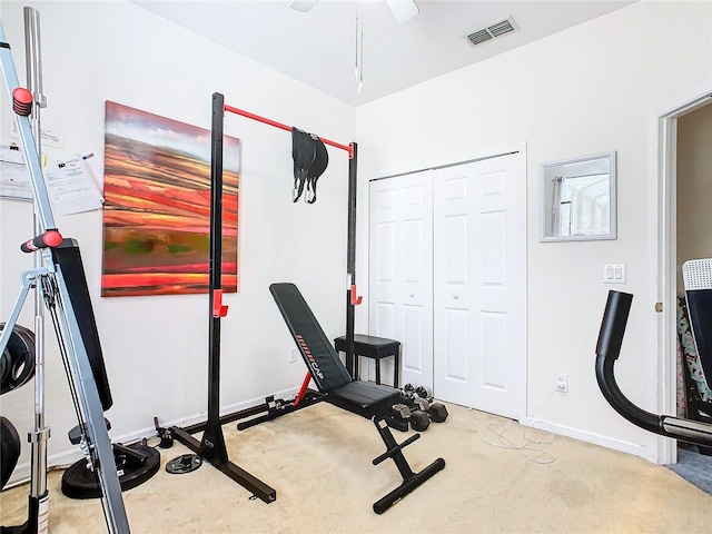 workout area featuring carpet and ceiling fan