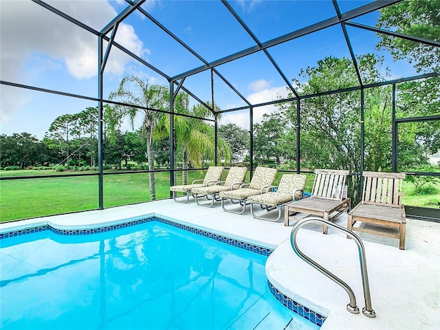 view of pool with a patio, a yard, and a lanai