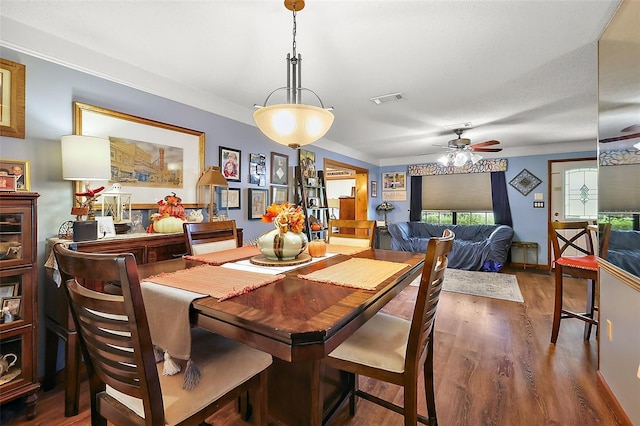 dining area with ceiling fan and dark wood-type flooring