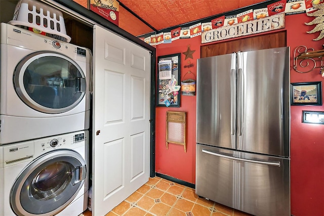 washroom with stacked washing maching and dryer