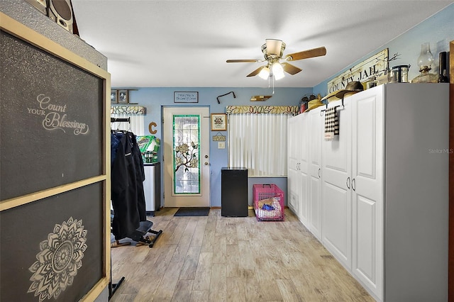 kitchen with ceiling fan and light hardwood / wood-style flooring