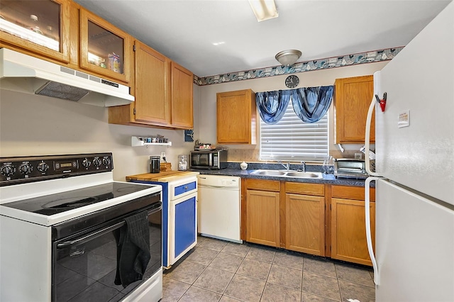 kitchen featuring white appliances, light tile patterned flooring, and sink