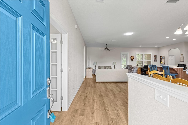 foyer entrance with light wood-type flooring and ceiling fan