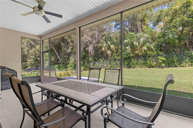 sunroom featuring ceiling fan and plenty of natural light