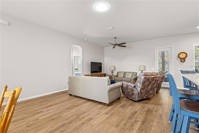 living room featuring light wood-type flooring and ceiling fan