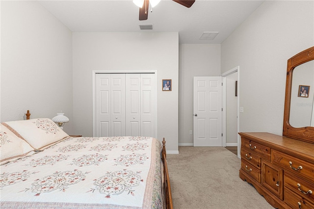 bedroom with a closet, ceiling fan, and light colored carpet