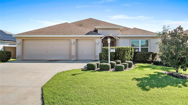 view of front of house featuring a garage and a front yard