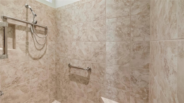 interior details featuring a tile shower