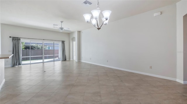 empty room with ceiling fan with notable chandelier and light tile patterned floors