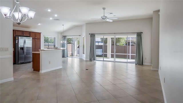 kitchen with pendant lighting, ceiling fan with notable chandelier, stainless steel fridge, and plenty of natural light