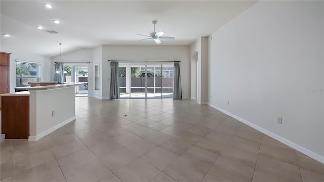 unfurnished living room with light tile patterned floors, lofted ceiling, and ceiling fan