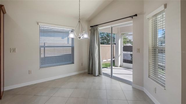 interior space featuring an inviting chandelier, lofted ceiling, and light tile patterned floors