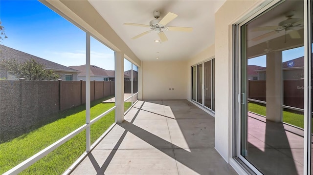 sunroom featuring ceiling fan