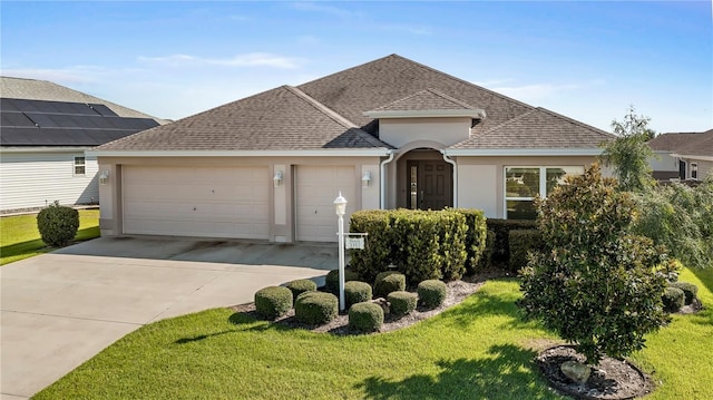 single story home featuring a garage and a front lawn