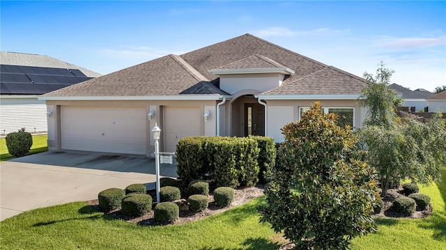 view of front of property with a garage and a front yard