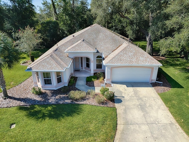 view of front of property featuring a front lawn and a garage