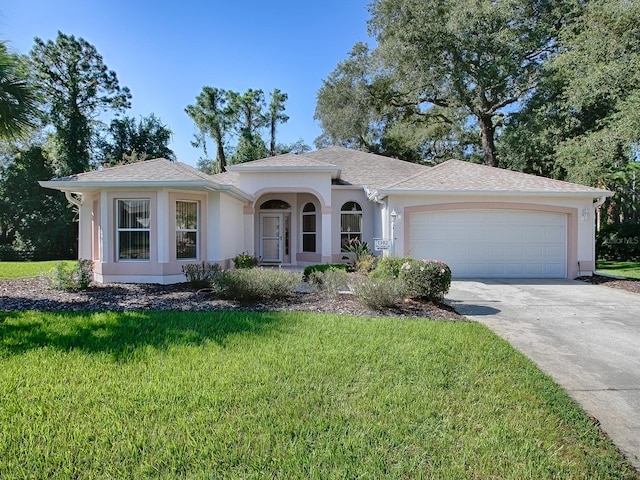 view of front of home with a garage and a front lawn