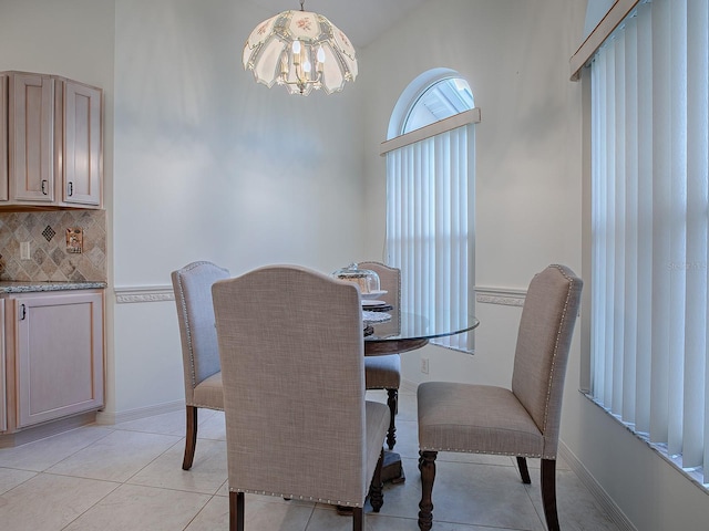 dining space with an inviting chandelier and light tile patterned flooring