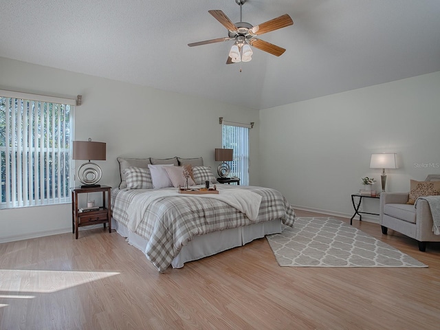 bedroom with hardwood / wood-style floors, ceiling fan, and lofted ceiling