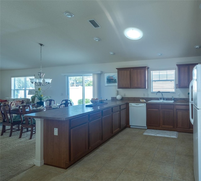 kitchen featuring white appliances, sink, and a wealth of natural light